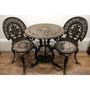 A three-piece garden set, 20th century, the cast aluminum alloy…