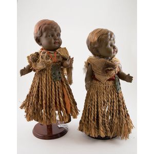 Two brown celluloid character toddler dolls with Maori dress…