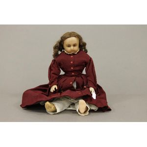 A mid 19th century wax doll with inset glass eyes, with a range…