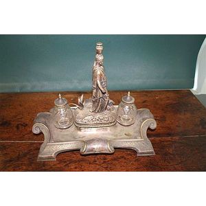 A late-Victorian nickel-silver standish, centred by a…