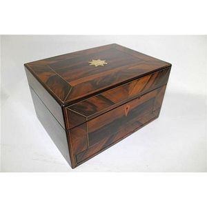 A Victorian coromandel and brass inlaid casket with hinged…
