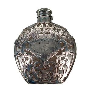 An Edwardian silver cased perfume bottle, the small flask form&hellip;