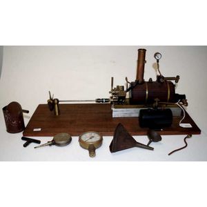 Early two cylinder live steam model engine connected to…