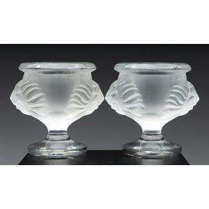 A footed pair of Lalique crystal Lion's head candle holders,…