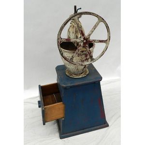 An south American cast iron coffee grinder on a solid painted…
