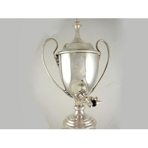 An Edwardian plated tea urn with a domed cover, tap and reeded…
