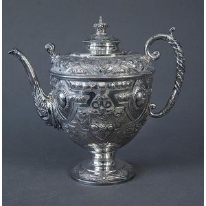 Early silverplated coffee pot. Ornate embossed decoration.…