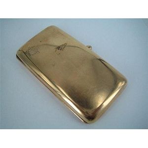 A gold cigarette case, plain rectangular, with cabochon…