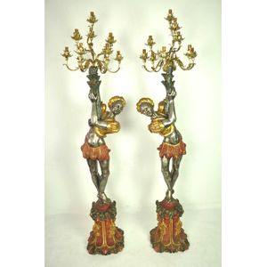 A pair of polychrome silvered and gilt Blackamoor candelabra,…
