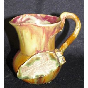 Australian Remued Pottery jug, with twig handle and gum leaf…