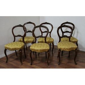 A set of six Victorian walnut dining room chairs.