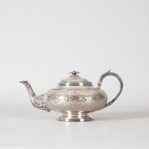 An ornate silver plated teapot, with a bulbous form and…