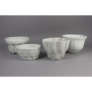 Four antique and later pottery jelly moulds, 14 cm high, 20 cm…