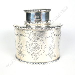 An early 1900s silver tea caddy, oval form with engraved…