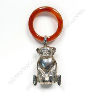 A silver and agate baby teething ring, a seated koala bear with…