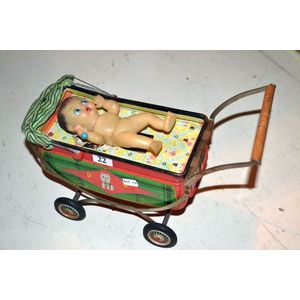 Vintage battery operated tin doll in pram toy, Japan