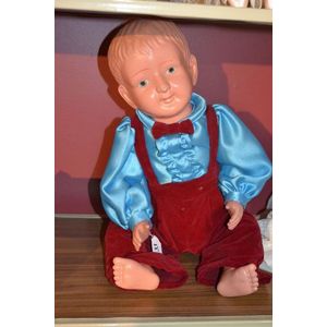 A Japanese Celluloid doll in velvet dinner suit, (slight dent…