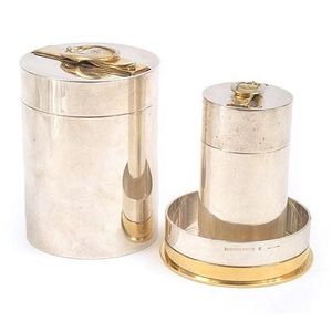 A smoking set by Hermes, comprising lighter, cigarette canister…