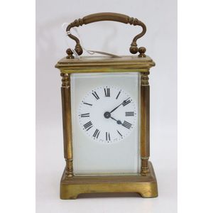 A modern brass carriage clock with bell-striking movement, the