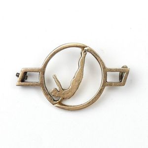 A vintage N.Z. 18ct. yellow gold swimming badge the circular…