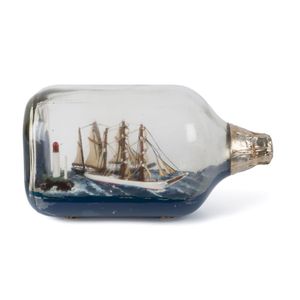A ship in a bottle display with two three mast tallships in…
