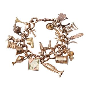 A charm bracelet, twenty-one assorted gold charms including a…