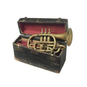 A cased brass cornet horn, 19th century, with original black…