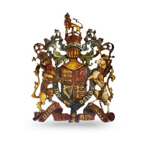 A cast iron panel of the British Coat of Arms, gilded and…