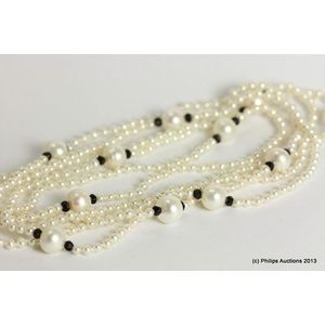 A stylish onyx and pearl necklace, strung as a very long…