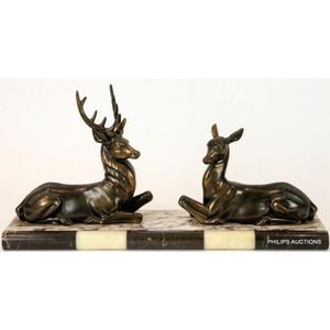 An Art Deco spelter deer group, circa 1930s, the recumbent stag…