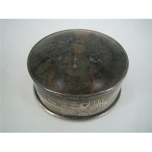A silver and tortoiseshell circular box with close-fitted…