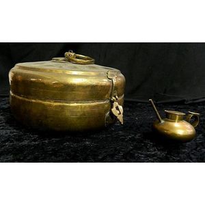 An Indian brass betel box and small oil pourer 25 cm diameter,…