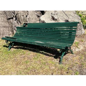 A green painted slatted wood metal garden seat 180 cm wide.