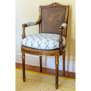 Louis XVI style chair with black and white stripes and gilded wood