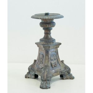 A continental brass candle holder with religious iconographic…