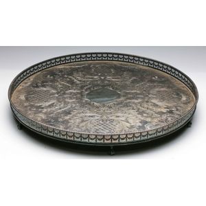 A large silver plated serving tray on ball and claw feet,…