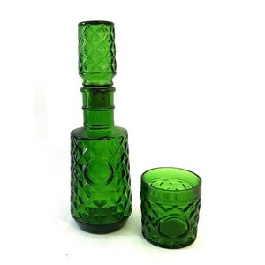A pressed green glass decanter and matching glass, height 28 cm