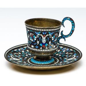 An enamelled Russian silver 875 teacup and saucer trio,…