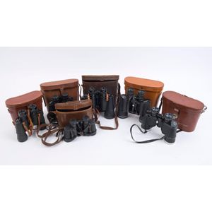 Six pairs of vintage binoculars in tan and brown leather cases,…