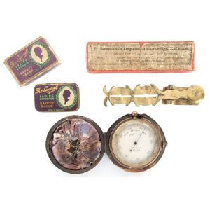 An antique pocket barometer in case, pocket sovereign scales…