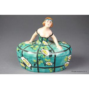 A French figural porcelain box, circa 1925, the lidded trinket…