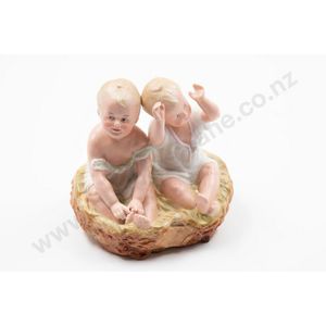 Probable Heubach bisque piano baby pair twin seated on rustic…