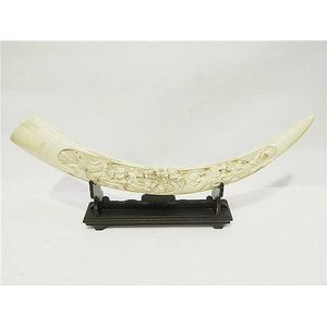 A simulated ivory resin tusk decorated with figural scene to…