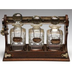 Antique oak tantalus with three decanters and 925 silver labels,…