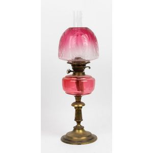 An Art Nouveau ruby glass banquet lamp, late 19th century, the…