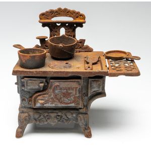 An early miniature crescent cast iron stove, length 32.5 cm