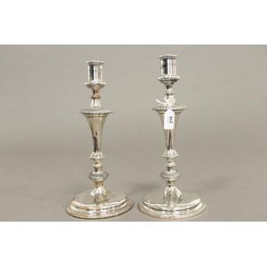 A pair of late Georgian Sheffield plate candlesticks of tapered…