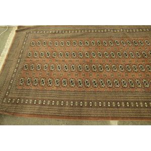 A finely woven Bokhara rug with multiple borders around a…