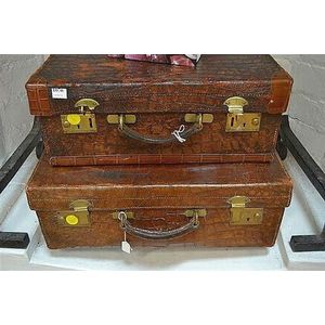 Two early 20th century British crocodile skin suitcases