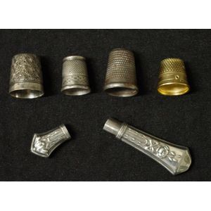 Collection of sewing implements comprising 4 various thimbles…